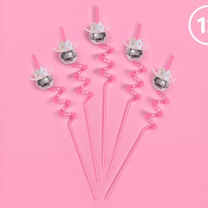 May include: Pink, curly straws topped with disco ball ornaments wearing miniature cowboy hats. The image shows six straws arranged on a pink background. A white circle with the number 12 is in the upper right corner.