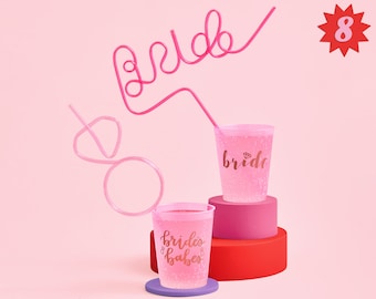 May include: Pink plastic cups with the words "bride" and "brides babes" printed on them. The cups are filled with a pink liquid and have pink bendy straws. There is a pink bendy straw shaped like the word "bride" in the background. The number 8 is printed on a red star in the top right corner of the image.