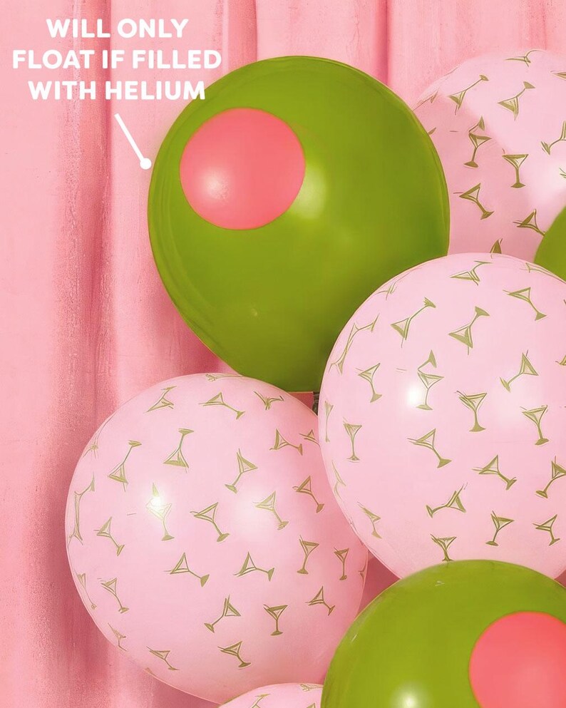 May include: A cluster of party balloons in shades of green and pink. Some balloons are olive green with a pink circle, resembling olives. Others are pink with a gold martini glass pattern. Text on the image reads: "WILL ONLY FLOAT IF FILLED WITH HELIUM."