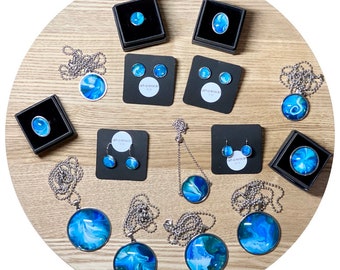 Wearable mini-art! Acrylic flow art paintings set under glass domes in beautiful, durable stainless steel jewellery.