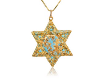 May include: A gold-colored Star of David pendant necklace. The pendant features a six-pointed star design with turquoise blue accents and a central design. The necklace chain is a delicate gold color.