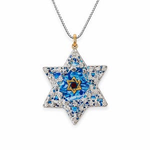 May include: A Star of David pendant necklace featuring a silver-tone filigree frame filled with blue and white marbled enamel. A smaller gold-tone Star of David with a central red stone is set in the middle, suspended from a silver box chain.