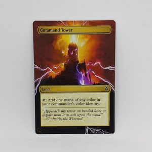 Puede incluir: Una carta de Magic: The Gathering llamada "Command Tower". Es una carta de tierra que te permite añadir una mana de cualquier color en la identidad de color de tu comandante. El arte de la carta representa una alta torre de piedra que es golpeada por un rayo.