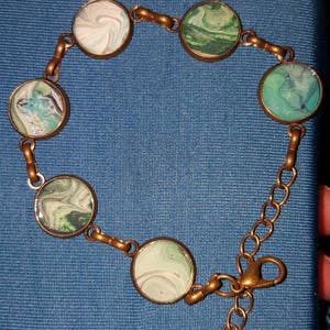 Light weight, hand painted antique bronze finished bracelet in black white and green.