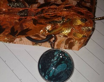 Hand painted, glass cabochon with black metal pendant