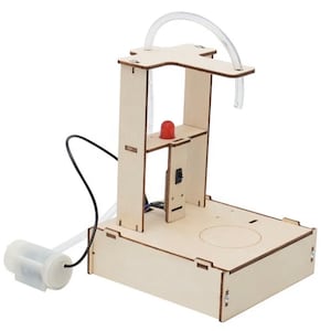 May include: A wooden science kit featuring a clear plastic tube, a red LED light, and a small pump. The kit is designed to teach about water pressure and gravity.