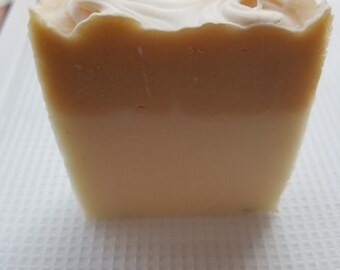 May include: A rectangular bar of soap with a light yellow top layer, a lighter yellow middle layer, and a white bottom layer.