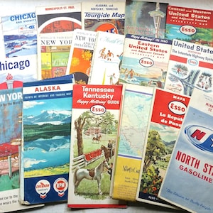May include: A collection of vintage travel maps and guides featuring various locations across the United States, Alaska, and Canada. The maps are printed on paper and feature colorful illustrations and text. The maps are from the 1950s and 1960s and are in good condition. The maps are all from the Esso brand.