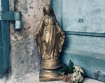 A small silver vintage French statue of the Virgin Mary and child