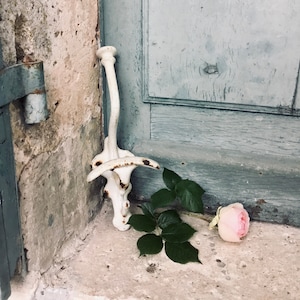 A fantastic antique French white enamel heavy coat hook and hat.  French bathroom