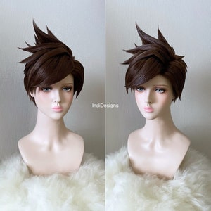 May include: A brown short cosplay wig with a spiky style. The wig is styled with a side part and is worn on a mannequin head with a white fur collar.