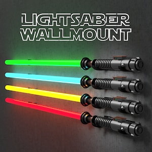 May include: A wall mount for lightsabers, featuring five lightsabers in different colours: green, blue, yellow, red, and black. The lightsabers are mounted on a wall with the text "LIGHTSABER WALLMOUNT" above them.