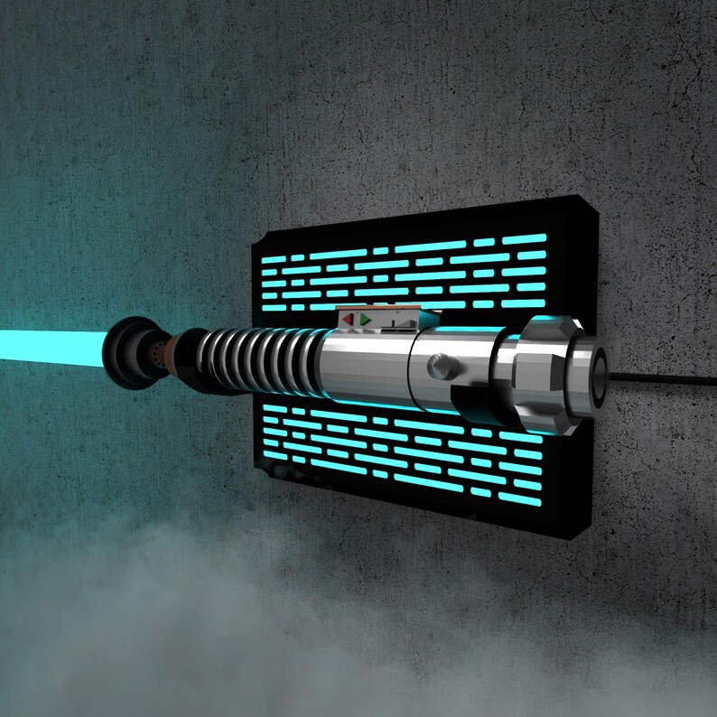 May include: A blue lightsaber with a glowing blade is mounted on a black rectangular wall fixture with blue lights. The lightsaber has a silver handle and is set against a gray concrete wall.