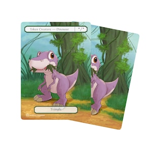 May include: Two fantasy art cards featuring a purple dinosaur. The cards have the text "Token Creature - Dinosaur" and "Trample". The dinosaur is holding leaves in its mouth. The background shows a forest scene with green trees and grass.
