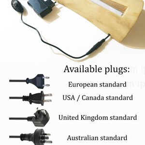 May include: A wooden base with a light source inside. The base is connected to a power adapter with a cord and a plug. The image shows four different types of plugs: European standard, USA/Canada standard, United Kingdom standard, and Australian standard. The text on the image reads: "Available plugs: European standard, USA/Canada standard, United Kingdom standard, Australian standard. A PayPal account is not necessary to make a payment. You can choose "Pay with a credit card". PayPal secures the transfer."