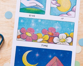 May include: A whimsical art print with a comic strip style. The print features panels with the words "GIVE IT TIME" and illustrations of a hand, a sun, flowers, a crescent moon, and a mountain.