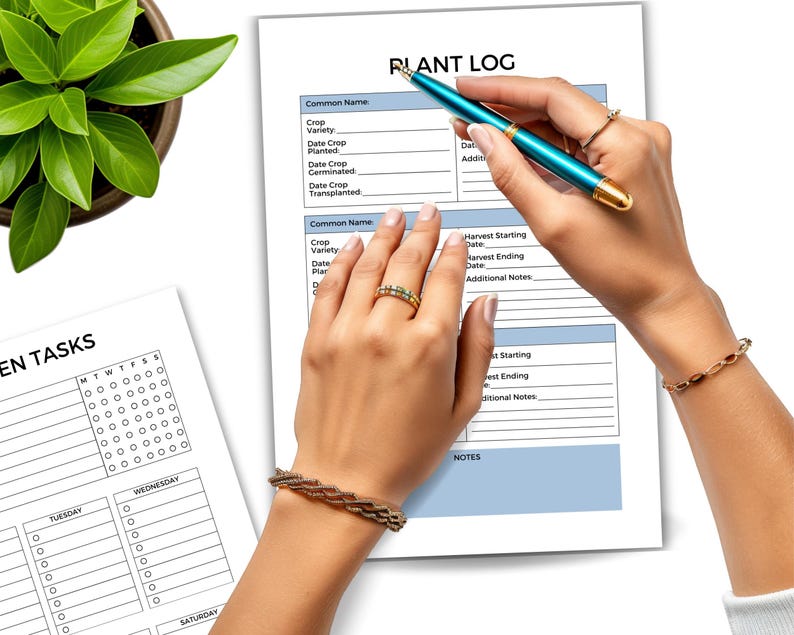 May include: A close-up of a plant log and garden tasks planner. The plant log has fields for common name, crop variety, and dates. A teal pen is held over the log. A potted plant is in the upper left corner.