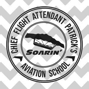 May include: Black and white circular graphic with the text "CHIEF FLIGHT ATTENDANT PATRICK'S AVIATION SCHOOL" around the edge. The center features a hang glider and the word "SOARIN'". The background has a gray and white chevron pattern.