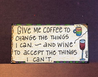 May include: A colorful wooden sign with the text "Give me coffee to change the things I can. and wine to accept the things I can't."  The sign features a cartoon coffee cup and a glass of wine.