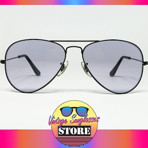 May include: Black aviator sunglasses with gray lenses. The sunglasses have a classic design and are in good condition.