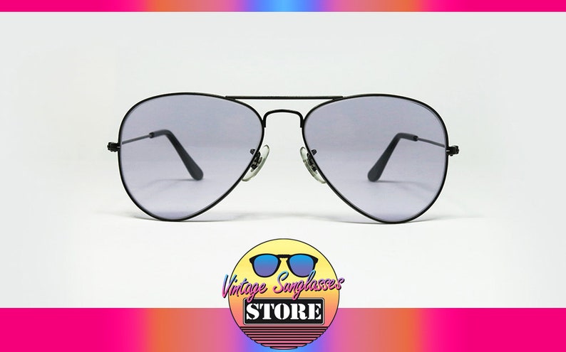 May include: Black aviator sunglasses with gray lenses. The sunglasses have a classic design and are in good condition.