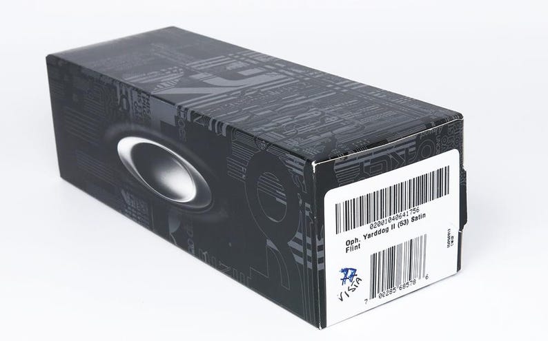 May include: A black rectangular box with a silver oval logo and a white label with a barcode. The box has a patterned design and the text "Oph. Yarddog II (53) Satin".