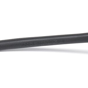 May include: Close-up of a black eyeglass arm with a rubberized grip. The text "MADE IN USA" is printed on the arm. The arm is black and has a curved shape.