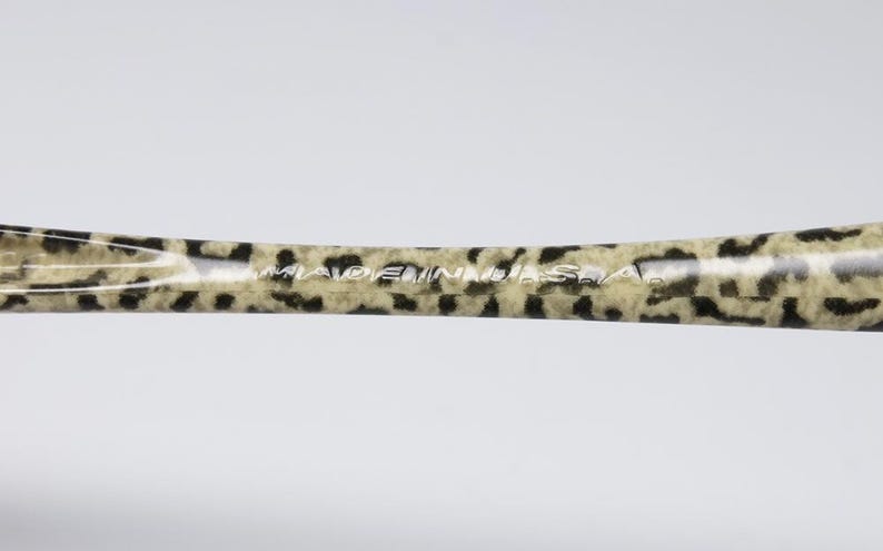 May include: A hair styling tool with a leopard print pattern in tan and black. The text "MADE IN U.S.A." is printed in white on the surface of the tool.