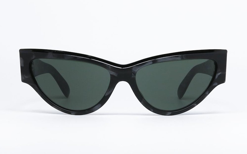 May include: Black cat-eye sunglasses with a tortoise shell pattern on the frame.