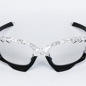 May include: White and black sports sunglasses with a unique design. The frames are white with a black pattern, and the arms and lower frame are black. The lenses are clear, and the overall style is modern and sporty.
