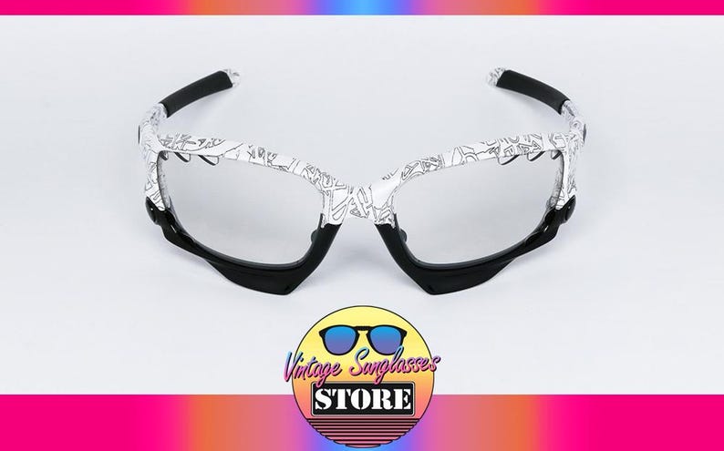 May include: White and black patterned sunglasses with a black frame and arms. The lenses are clear. The image includes a logo for Vintage Sunglasses Store.