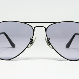 May include: Black aviator sunglasses with gray lenses.