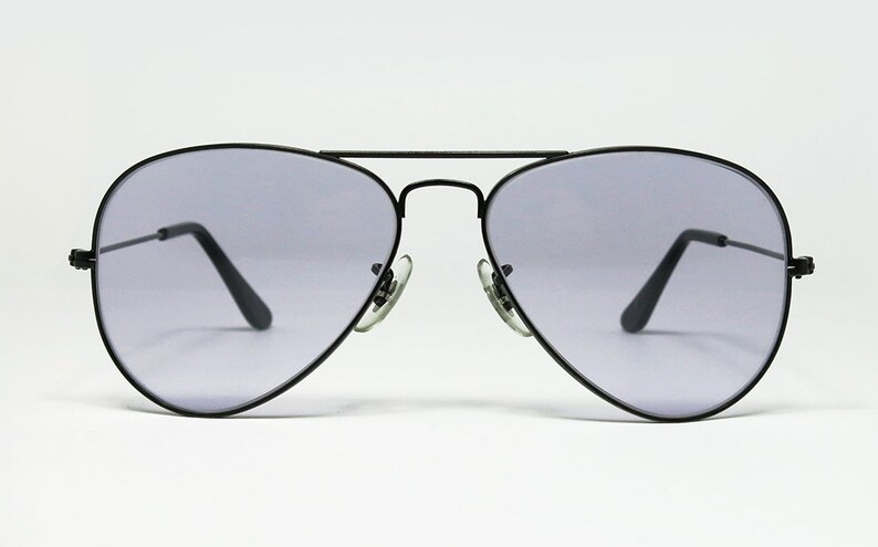 May include: Black aviator sunglasses with gray lenses.