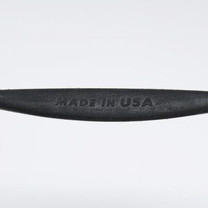 May include: Close-up of a black rubber handle with the text "MADE IN USA" embossed on it. The handle is attached to a metal object.