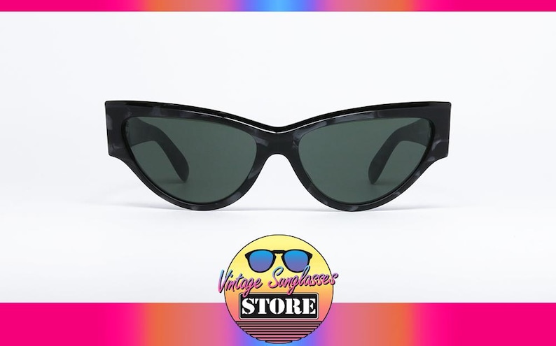 May include: Black cat-eye sunglasses with a tortoise shell pattern frame and dark lenses.