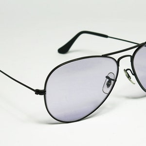 May include: Black aviator sunglasses with a light purple tint to the lenses.