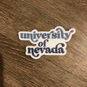 May include: A white sticker with blue text that reads "university of nevada" in a retro font.