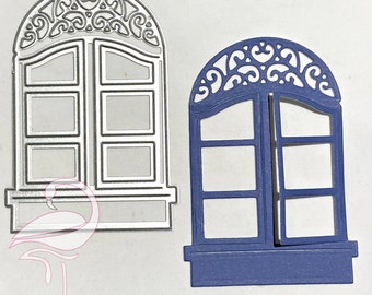 Puede incluir: Dos marcos de ventana troquelados de metal. El marco de la izquierda es plateado y tiene una parte superior decorativa. El marco de la derecha es azul y tiene una parte superior decorativa.