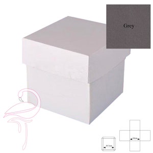 May include: A white square gift box with a matching lid. The box has a simple design and is suitable for various occasions. A small swatch of grey fabric is in the upper right corner. The box dimensions are 10.5 cm x 10 cm.