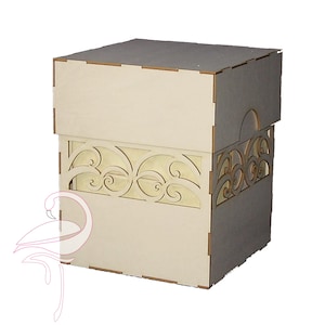 Peut inclure: Une boîte en bois avec un motif découpé décoratif sur le devant. La boîte est en bois clair et a un couvercle à charnière.