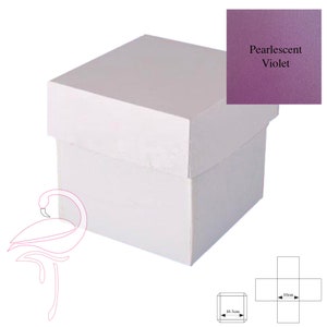 May include: A white square gift box with a lid. The box is 10 cm wide and 10 cm long. The box is made of cardboard and has a smooth finish. The box is shown closed with the lid on top. The box is shown on a white background.
