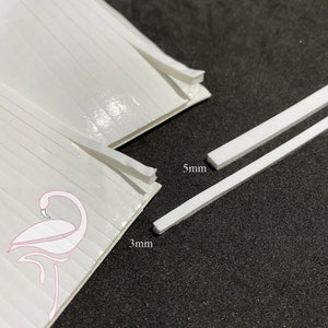 May include: Two white adhesive strips, one 3 mm wide and the other 5 mm wide. The strips are shown on a black surface.
