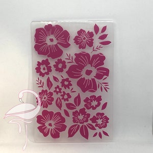 May include: A clear plastic sheet with a pink floral design. The design features various sizes and shapes of flowers, including large, medium, and small flowers.