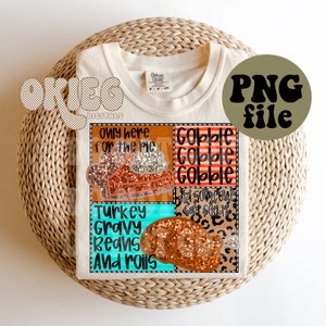 May include: A white t-shirt with a Thanksgiving-themed design. The design features a patchwork of different patterns, including a pie, a turkey, and the words "Gobble Gobble Gobble".