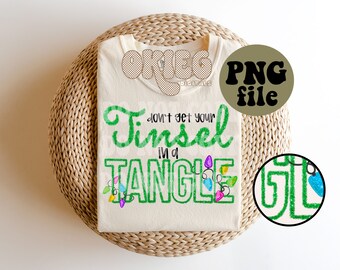May include: A white t-shirt with green glitter text that reads "Don't get your tinsel in a tangle". The text is surrounded by colorful Christmas lights.