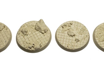 May include: Five beige, round miniature bases with a textured, grid-like pattern. Each base has a rough, uneven surface with small, scattered rock-like details, suggesting a terrain or battlefield setting for miniature figures.
