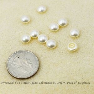 May include: A pack of 10 cream-coloured, 8mm Swarovski 5817 pearl cabochons. The pearls are shown next to a US quarter for size reference.  Swarovski 5817 8mm pearl cabochons in Cream, pack of 10 pieces