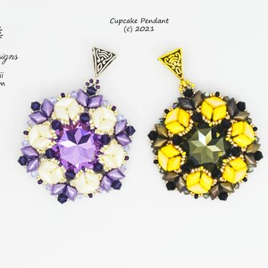 May include: Two beaded cupcake pendants, one with a purple and white design and the other with a yellow and black design. Both pendants feature a crystal center and a silver or gold bail.