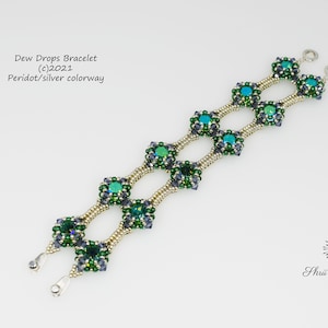 May include: A green and silver beaded bracelet with a square design. The bracelet is labeled "Dew Drops Bracelet (c) 2021 Peridot/silver colorway".