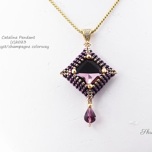May include: A gold chain necklace with a square pendant featuring a purple and black crystal surrounded by gold and black beads. The pendant has a small purple teardrop hanging from the bottom. The text "Catalina Pendant (c)2023 Amethyst/champagne colorway" is visible in the image.